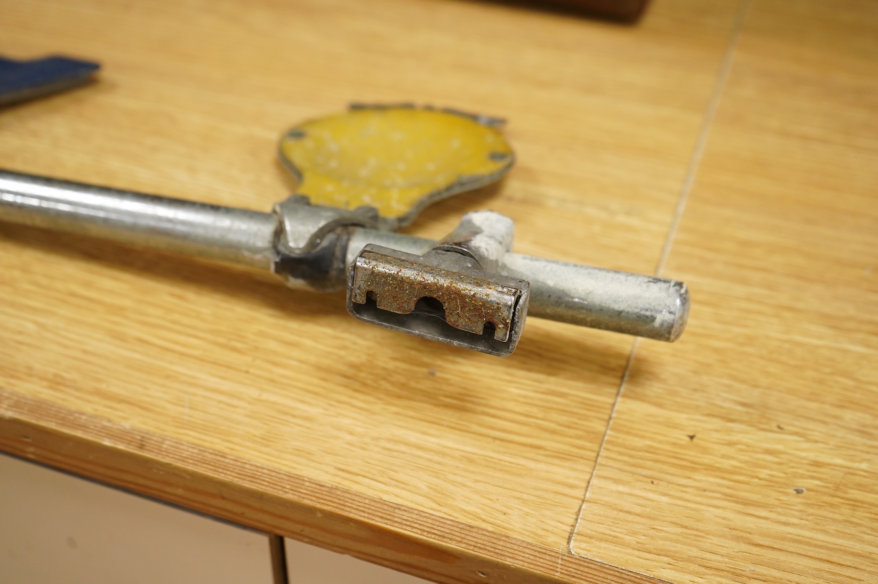 Three car badges to include RAC and AA, mounted on a bar, 67cm in length